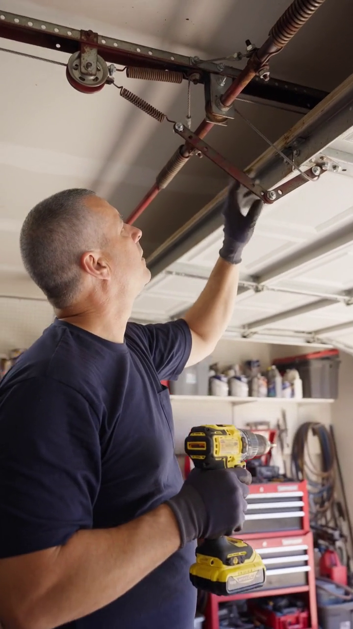 A garage door technician at work